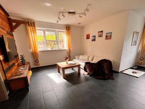 a living room with a couch and a table at Ferienwohnung Krenz in Uhldingen-Mühlhofen