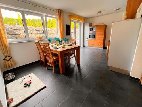 a kitchen and dining room with a table and chairs at Ferienwohnung Krenz in Uhldingen-Mühlhofen