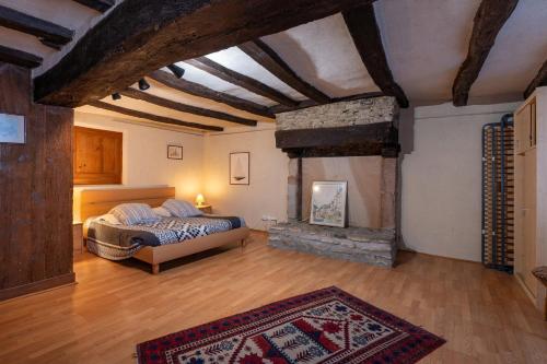 a bedroom with a bed and a fireplace at Maison Sarzeau Centre - La Bernache in Sarzeau