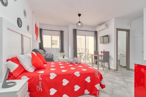 a bedroom with a red bed with red and white pillows at Nerja Boutique 101 Deluxe in Nerja