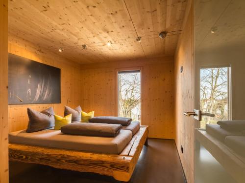 a bedroom with a bed with pillows on it at Ferienwohnungen Winzerhof Keller in Auggen