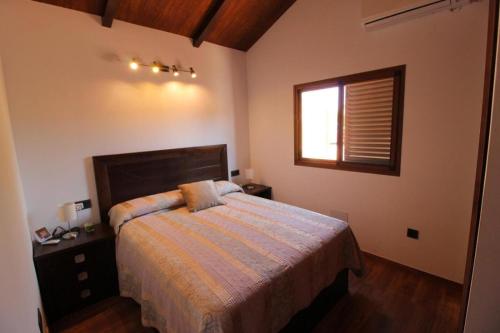 a bedroom with a large bed and a window at Casa Bellavistas in Vejer de la Frontera
