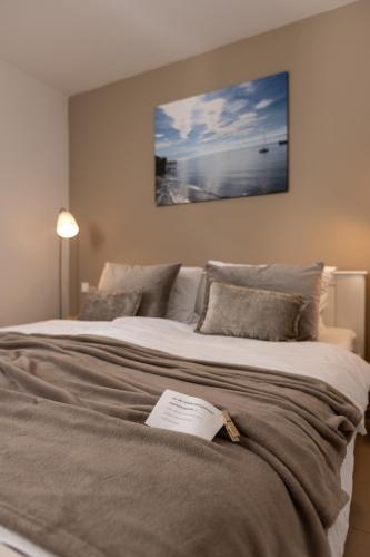 a bedroom with a large bed with a book on it at Claudia's Seeherz in Wasserburg
