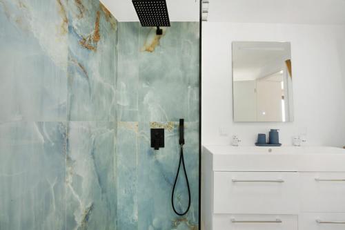 a bathroom with a shower and a sink at Seaside Haven - Soulful Stays in Porto Moniz