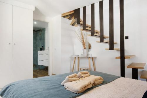 a bedroom with a bed with two towels on it at Seaside Haven - Soulful Stays in Porto Moniz