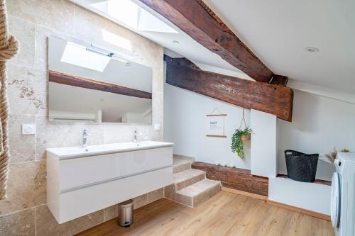 a bathroom with a sink and a mirror at Le Somail - Louis 14 in Ginestas