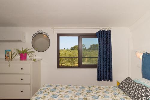 a bedroom with a bed and a window at Il Nazareno - Il Gheppio in Cecina