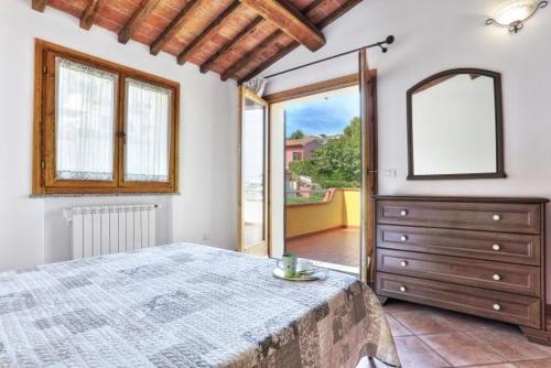 a bedroom with a bed and a dresser with a mirror at Casa Consuelo App. 2 (trilocale) in Capoliveri