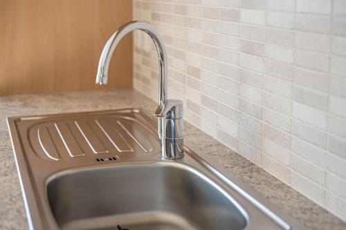 a kitchen sink with a faucet on a counter at Apartment Dolomitenblick in Mühlbach