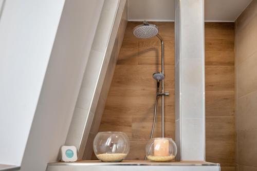 two glass vases sitting on a counter in a bathroom at Die Alter Schwede Wohnung 2 in Vechta