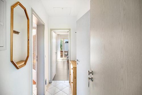 a hallway of a house with a mirror and a door at Ferienwohnungen Meyer in Hochbuch