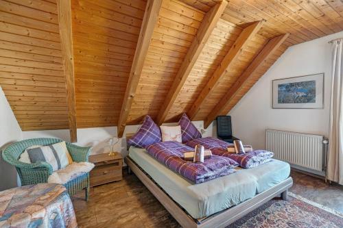 a bedroom with a bed and a wooden ceiling at Ferienwohnung Karin in Schonach