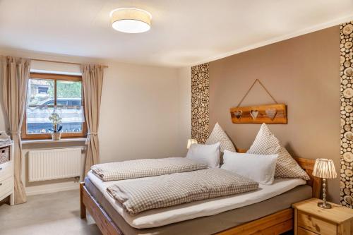 a bedroom with a bed and a window at Ferienwohnung Mair - Bergblick in Halblech