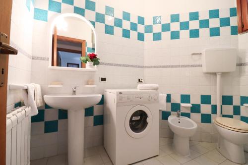 a bathroom with a washing machine and a sink at Casa Zara a Otranto in Otranto