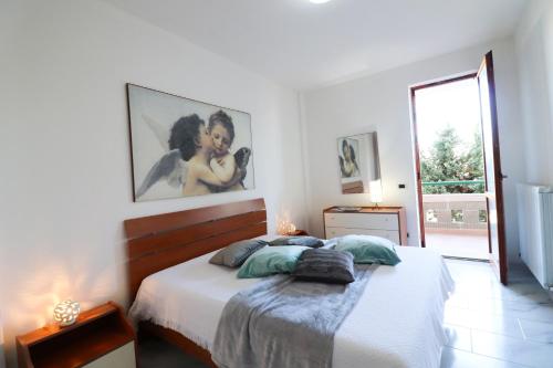 a white bedroom with a bed and a large window at Casa Zara a Otranto in Otranto