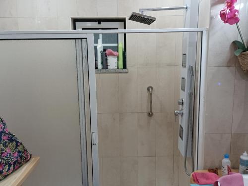 a shower with a glass door in a bathroom at Ká T'Espero in Penha Garcia