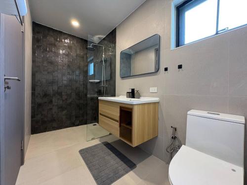 a bathroom with a sink and a shower and a toilet at Coconut Villa 8 in Ban Thung