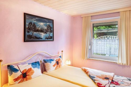 a bedroom with a bed and a window at Haus Seeblick in Malchow