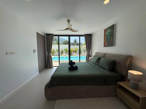 a bedroom with a bed with a teddy bear on it at Coconut Villa 8 in Ban Thung