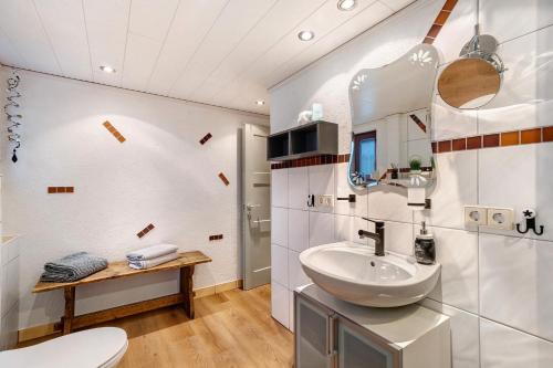 a bathroom with a sink and a toilet at Ferienwohnung im Salzgässle in Schonach
