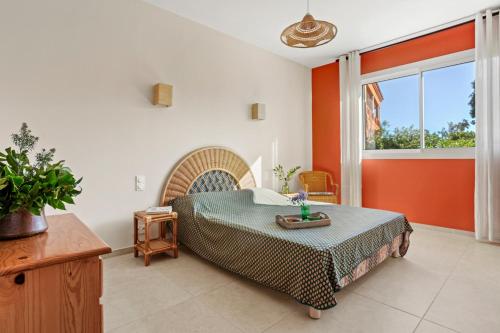 a bedroom with a bed and a large window at Villa Chantegrive in Roquebrune-sur-Argens