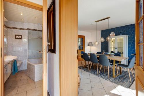 a dining room and kitchen with a table and chairs at Ferienhaus Ankerglück in Lensahn