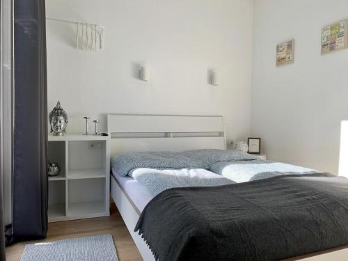 a bedroom with two beds and a white wall at Tiny Haus Liederbach in Alsfeld