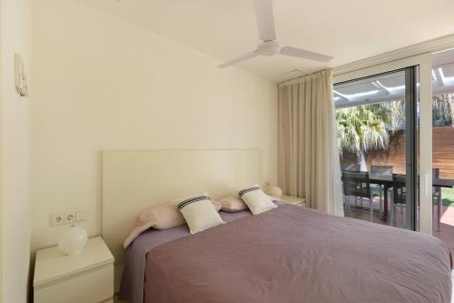 a bedroom with a large bed with a window at Casa Nirvana - Penthouse in Sitges