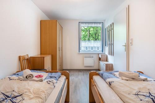 a bedroom with two beds and a window at Bungalow Bark Sedov, Bgl 3 in Dranske