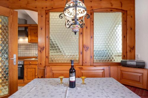 a bottle of wine sitting on a table in a kitchen at Ferienhaus im Grund in Hinterzarten