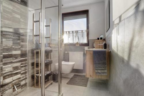a bathroom with a toilet and a glass shower at Mill Nordkirchen in Nordkirchen