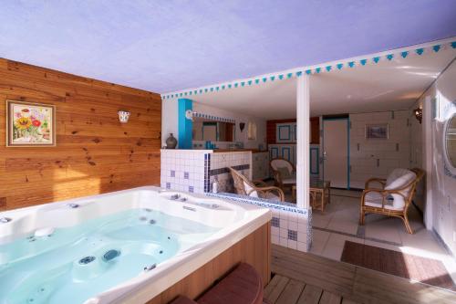 a large bathroom with a large tub in it at Chambres d'hôtes Le Pré Fleuri in Saint-Sulpice-de-Roumagnac