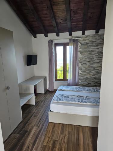 a bedroom with a large bed and a window at Agriotto Agriturismo in Savona