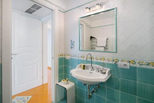 a bathroom with a sink and a mirror at Suite Tramonto in dependance in Conca dei Marini