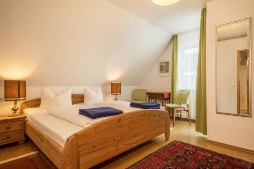 a bedroom with a large bed with blue pillows at Ferienwohnung Haidle in Eriskirch