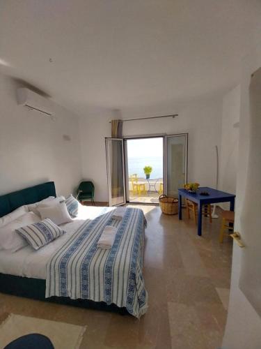 a bedroom with a bed and a view of the ocean at I Have A Dream in Agia Pelagia
