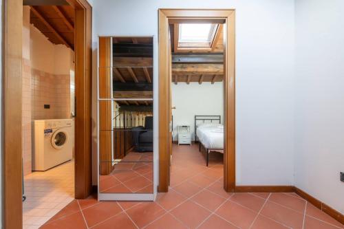 a hallway leading to a room with a washer and dryer at Dimora Oberdan 1800 - Duplex 70m from Arena 6 Beds in Verona