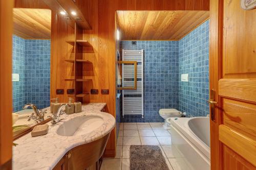 a bathroom with a sink and a tub and a toilet at La Libellula in Scopello