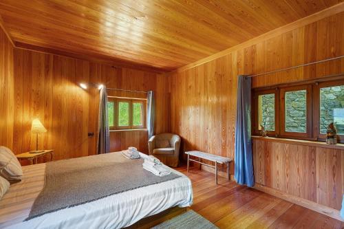 a bedroom with a bed in a wooden room at La Libellula in Scopello
