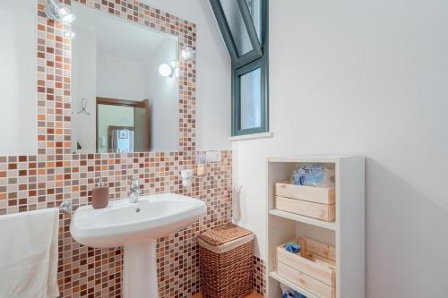 a bathroom with a sink and a mirror at Ciumara West in Avola
