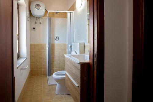 a bathroom with a toilet and a sink and a shower at Casa Arconides in Motta D'affermo