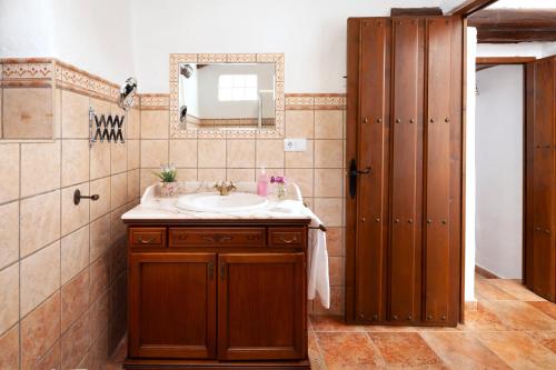 a bathroom with a sink and a mirror at Cortijo Salva in Periana