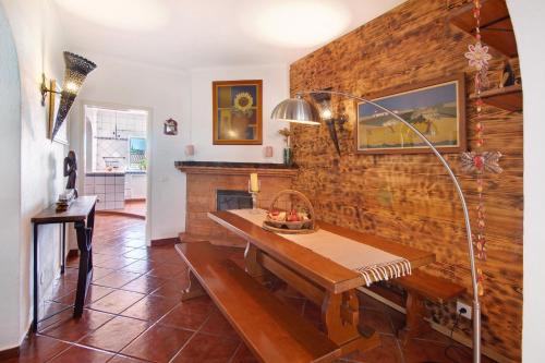 a dining room with a table and a wooden wall at Casa Terracota in Silves