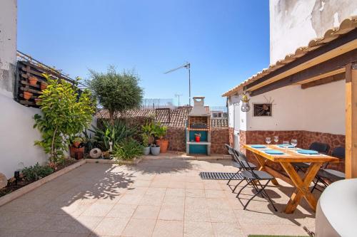 a patio with a wooden table and chairs at Casa Terracota in Silves