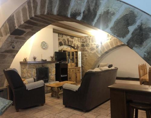 a living room with two chairs and a fireplace at Juderia I in Oña