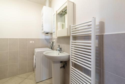 a white bathroom with a sink and a mirror at Papà Giuseppe La Cantina in Cortona