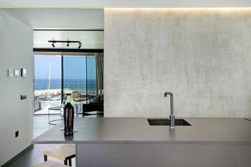 a kitchen with a sink and a view of the ocean at Suite Horizonte in Puerto del Carmen