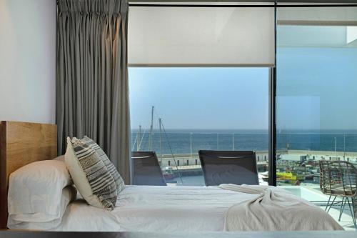 a bedroom with a bed and a view of the ocean at Suite Horizonte in Puerto del Carmen