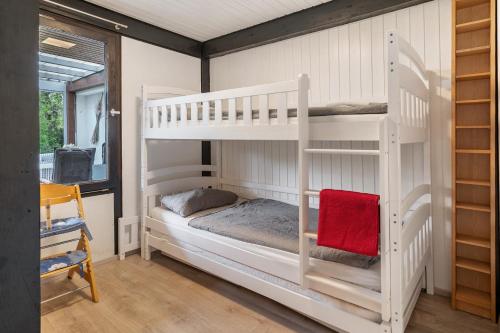 a bedroom with two bunk beds and a window at Bungalow Nordschwarzwald in Schellbronn