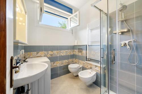 a bathroom with a sink and a toilet and a window at Ca Giannina in Bonassola